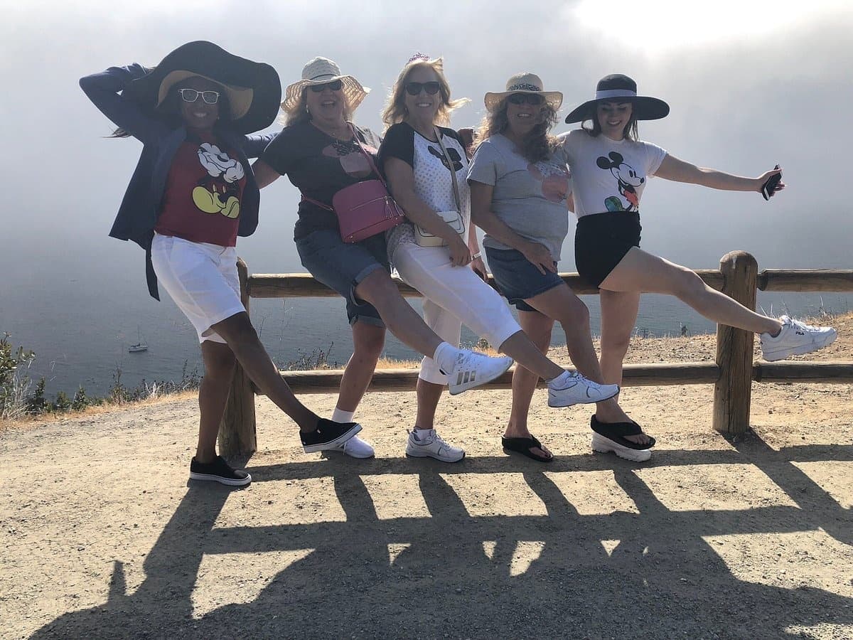 Women tourists posing on Catalina Island coastal overlook during hike