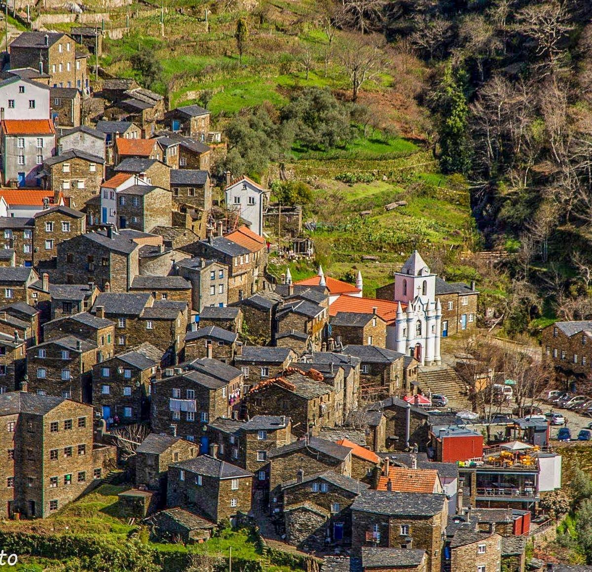 Historic hillside village with stone houses terraced on slopes