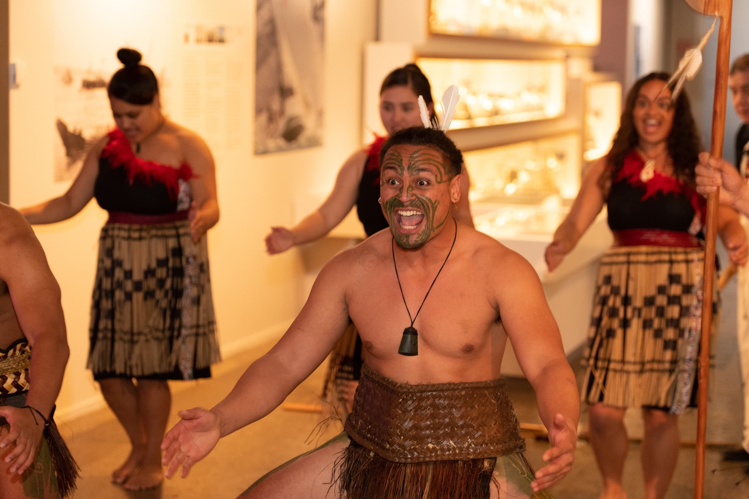 Maori performers doing haka inside museum cultural performance
