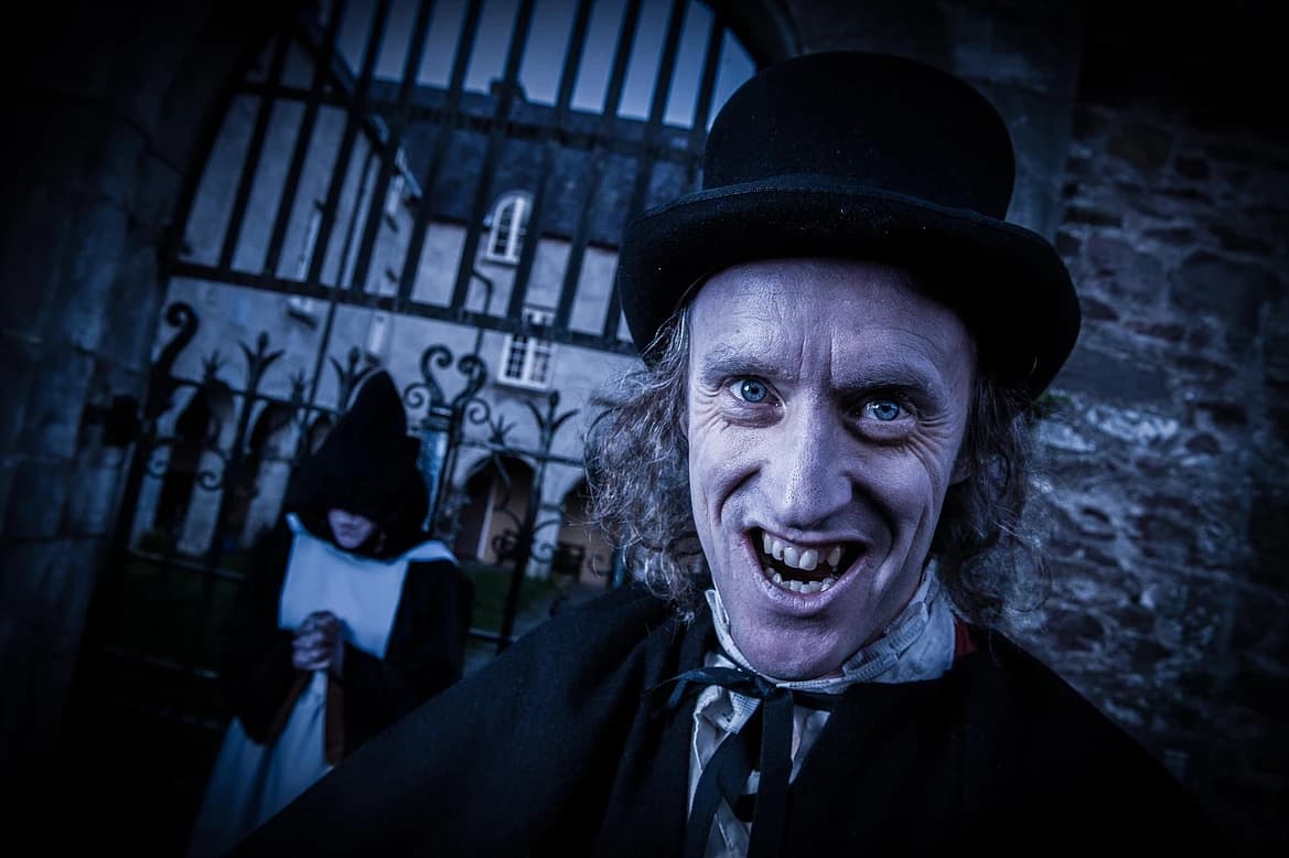 Actor in Victorian costume at eerie gate for Cork ghost tour