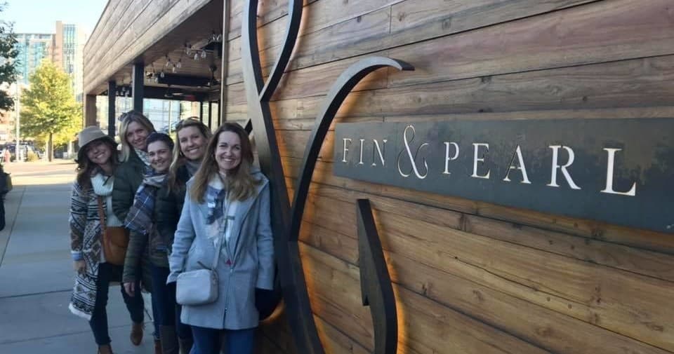 Group standing by wooden storefront exterior in Nashville