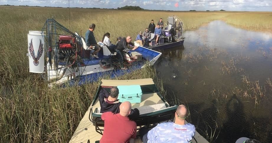 Guided airboat tour in Everglades with passengers and marsh
