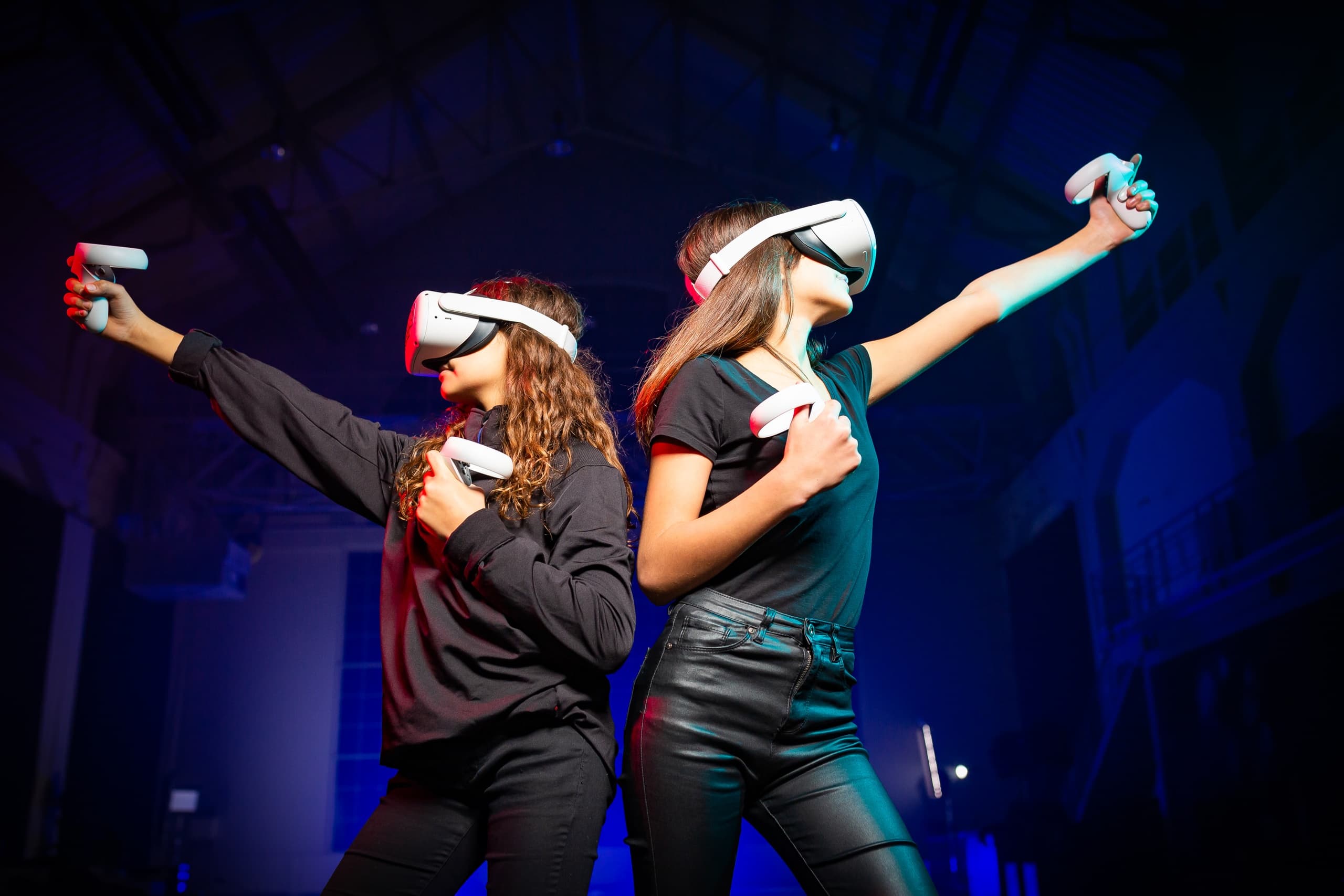 Two players wearing VR headsets posing for action in arcade hall
