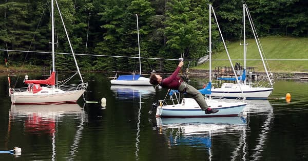 Ziplining over a calm marina with moored sailboats