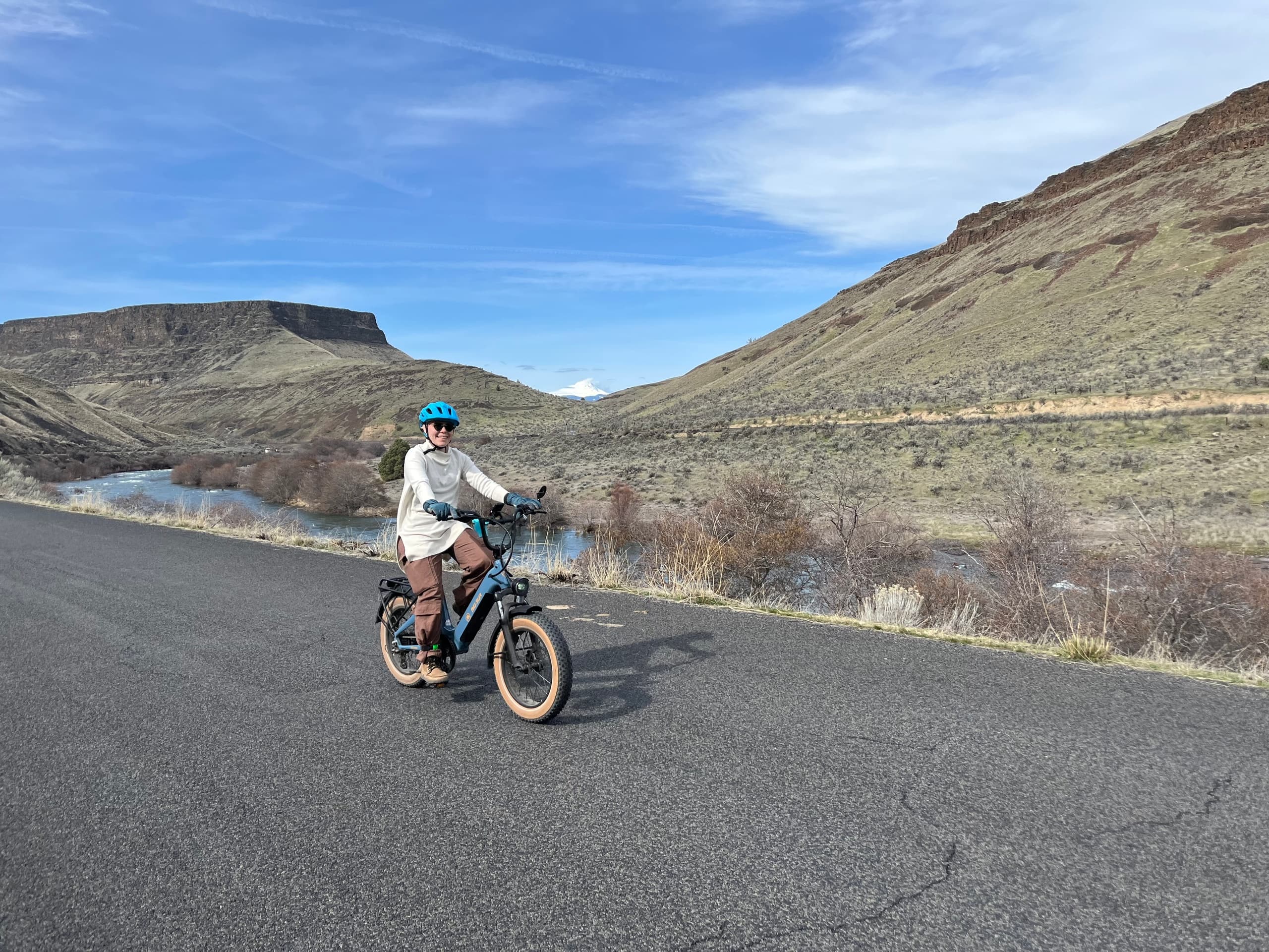 Solo rider on e-bike cruising open desert road