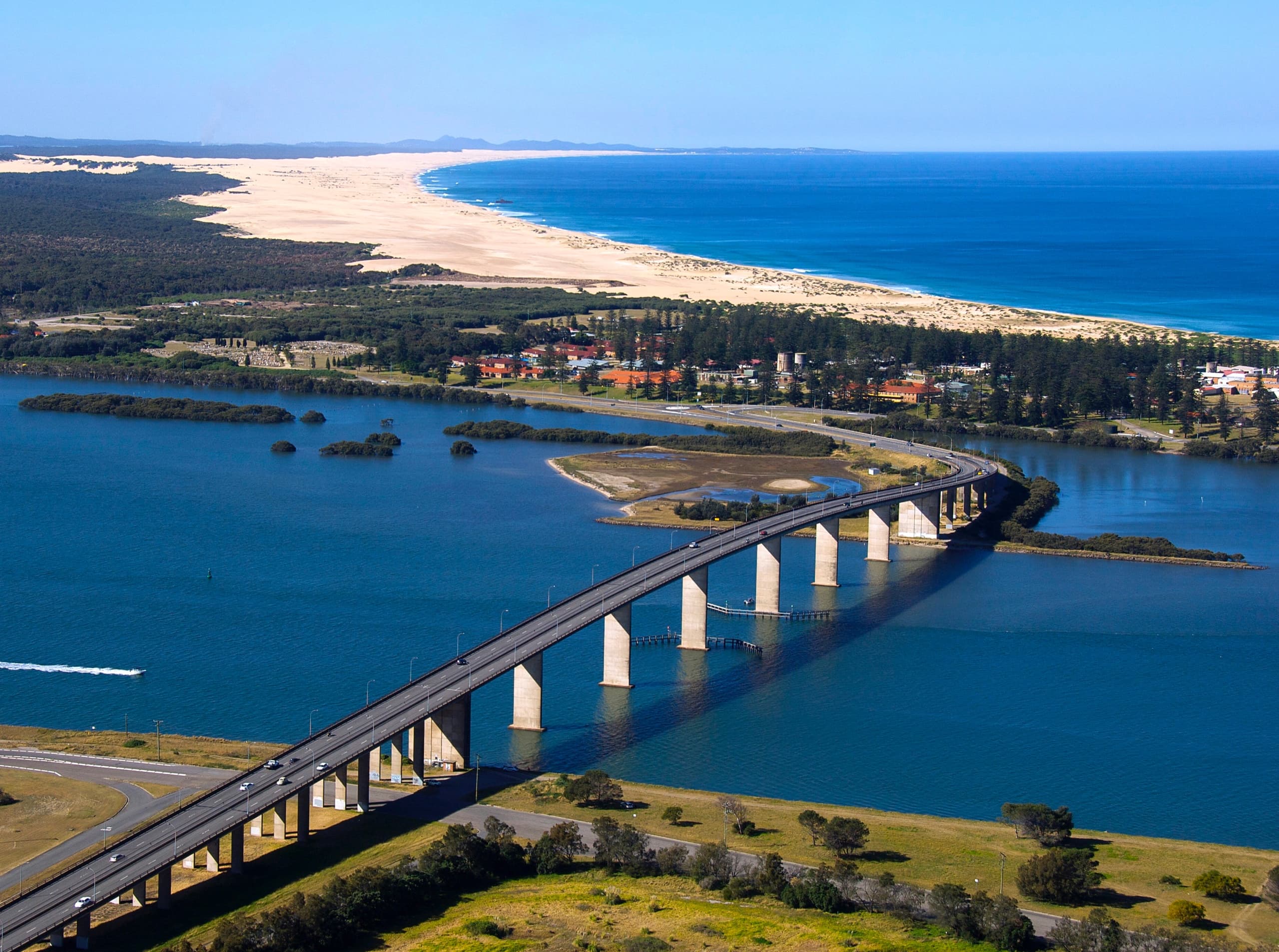 Scenic bridge aerial view from helicopter over estuary