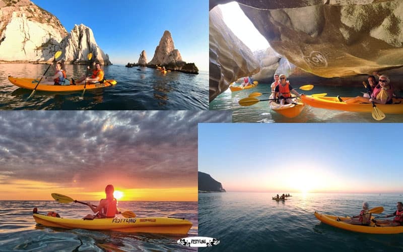 Sea kayaking near coastal sea caves and sunset off rocky cliffs