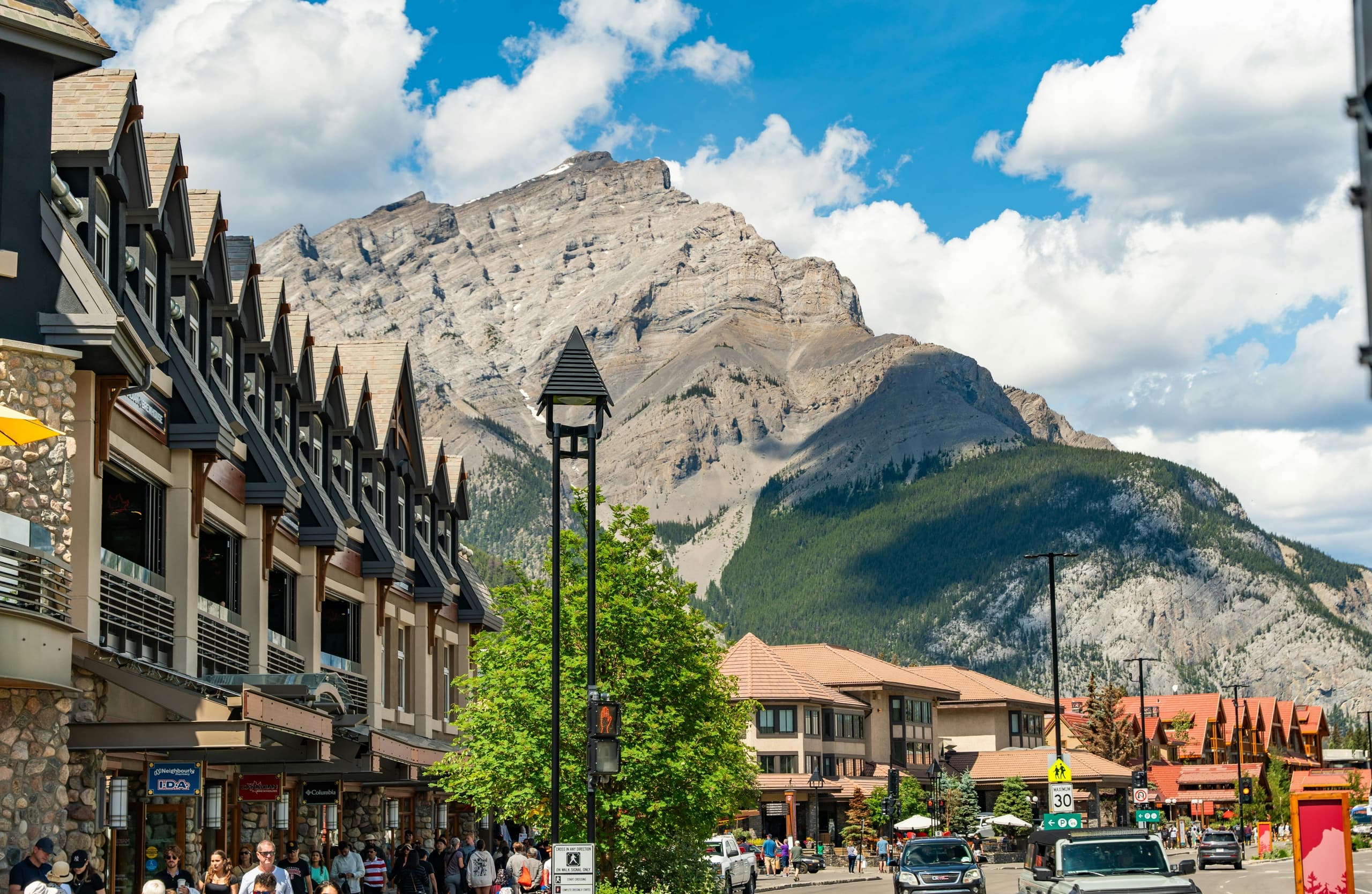 Mountain resort main street with shops and alpine peaks