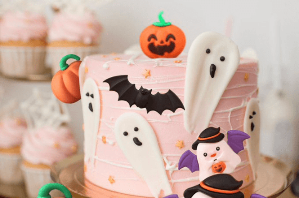 Halloween cake with ghost toppers from decorating class Greenville