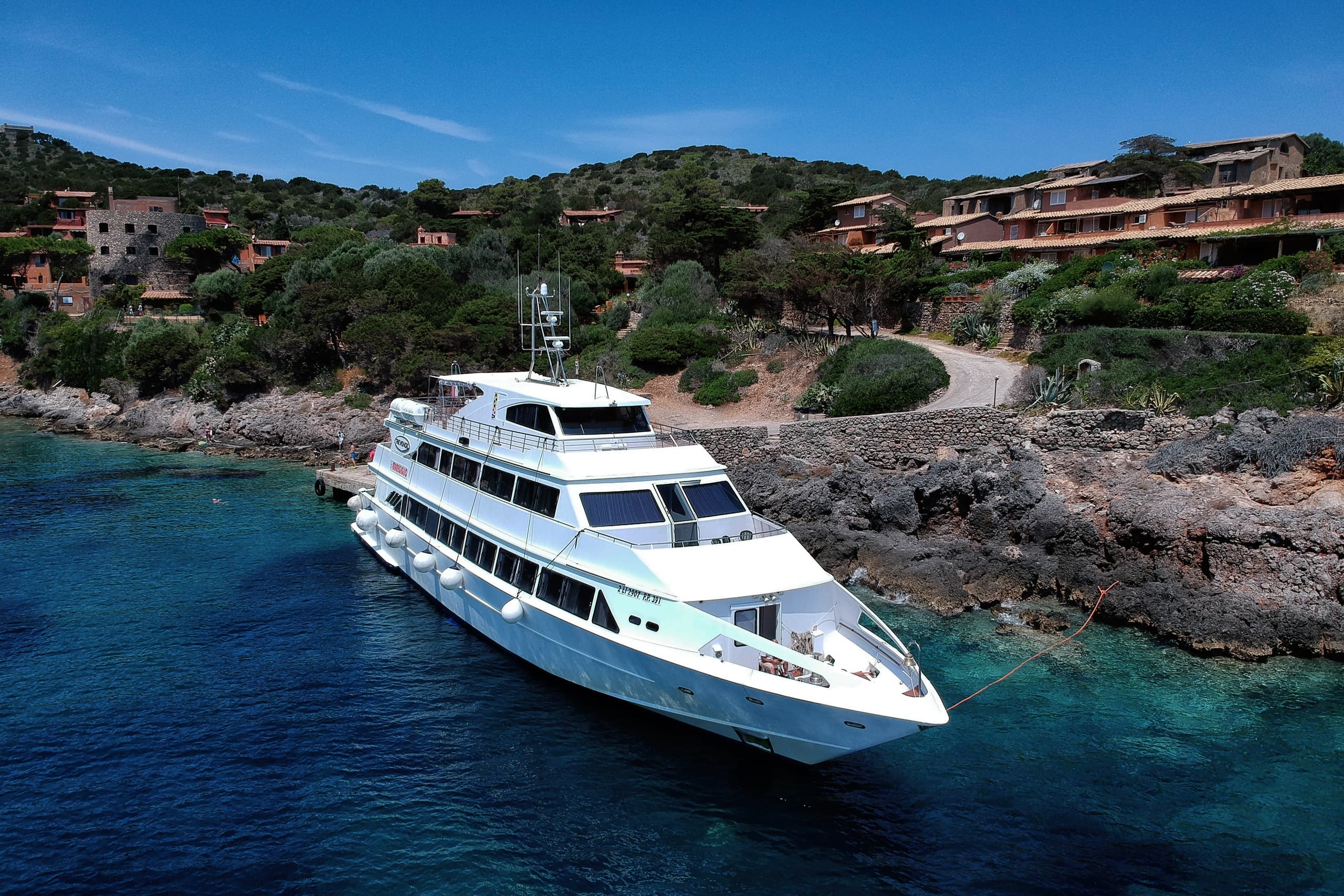 Luxury yacht cruising crystal Mediterranean waters, coastal Tuscany
