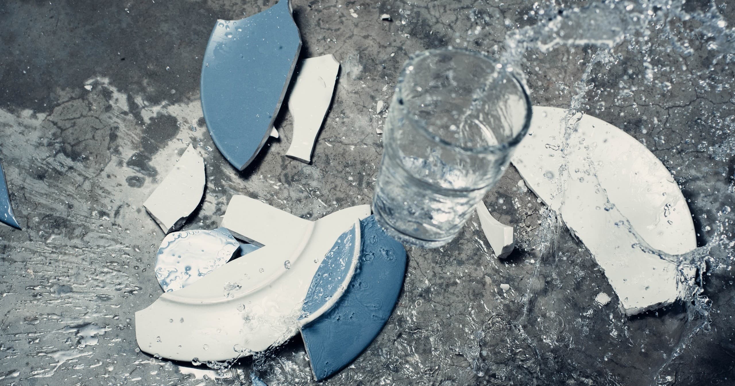 Shattered plates and glass on tabletop from indoor smash session