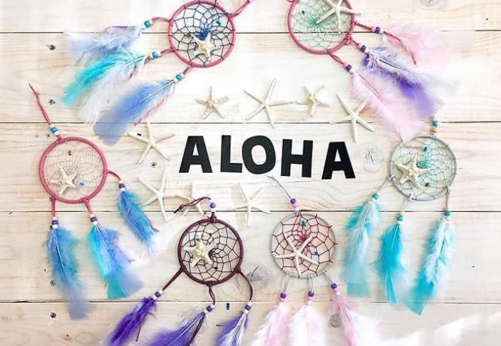 Beach-themed dreamcatchers with ALOHA sign on wooden backdrop