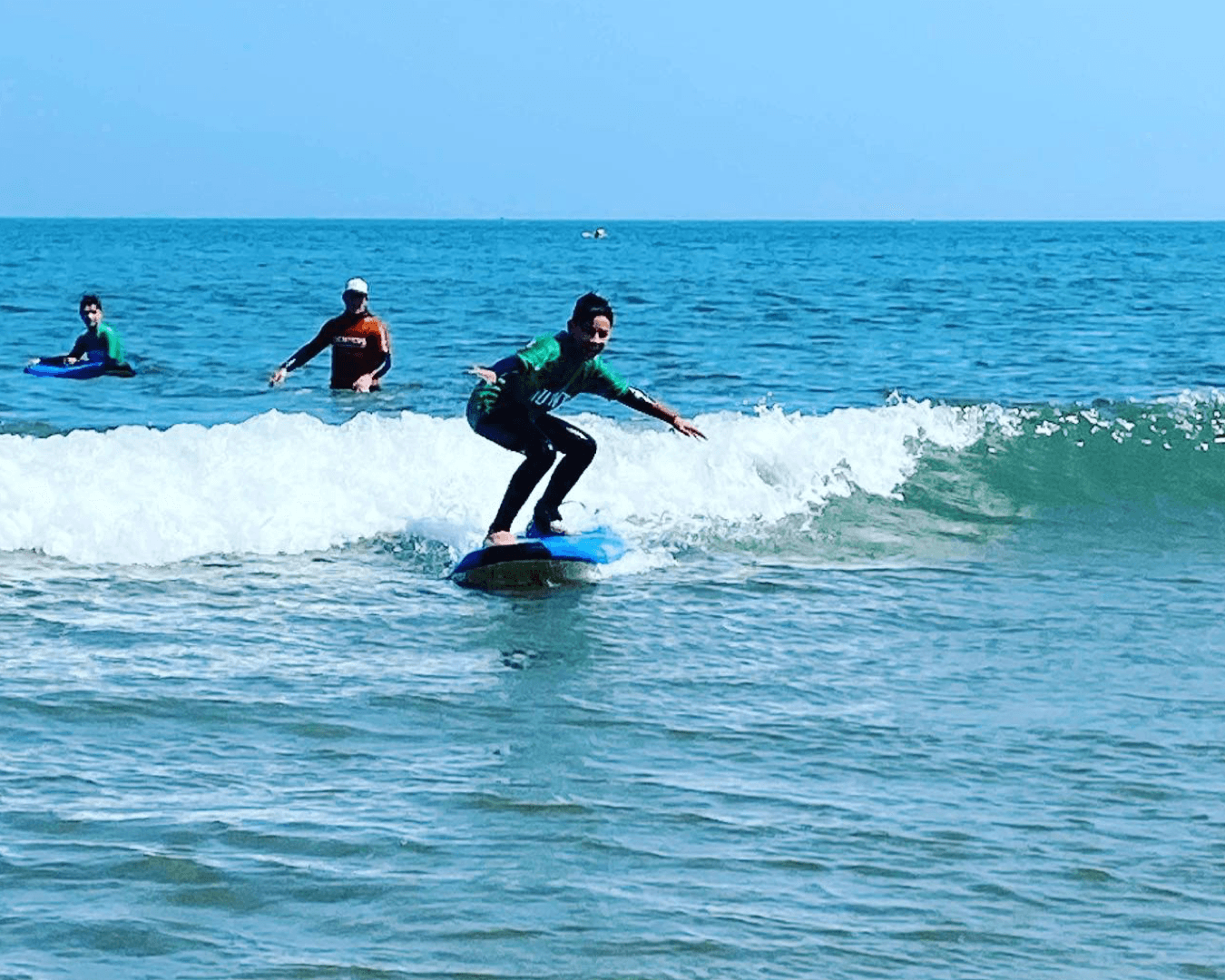 Surfer riding a clean wave in bright coastal ocean waters
