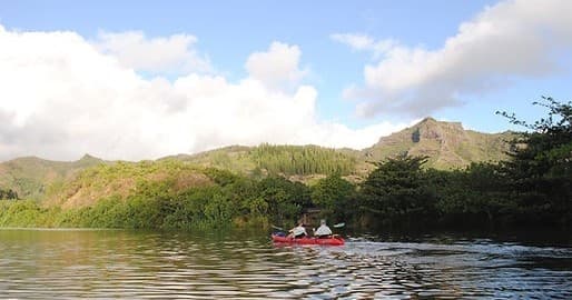 Kayakers paddling on Wailua River, Kauai through tropical valley