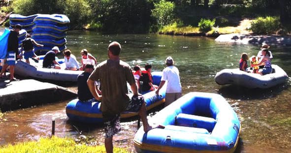 Rafts and guides preparing on Truckee River shoreline for trip