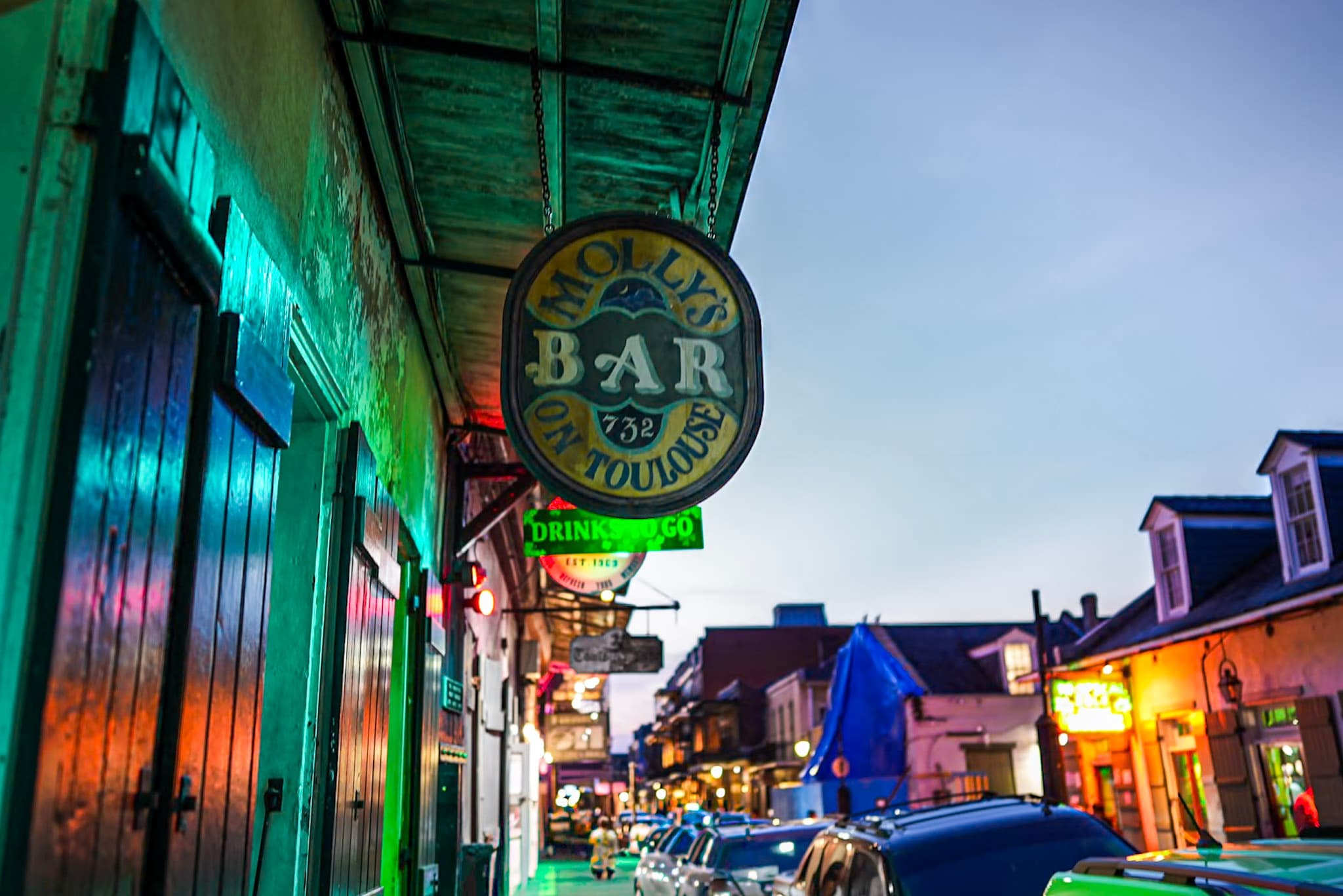 Bourbon Street nightlife with neon bar signs, New Orleans walk