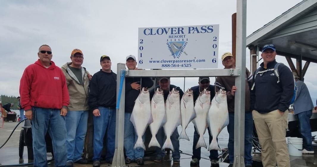 Group posing with halibut catch at Clover Pass dock in Alaska