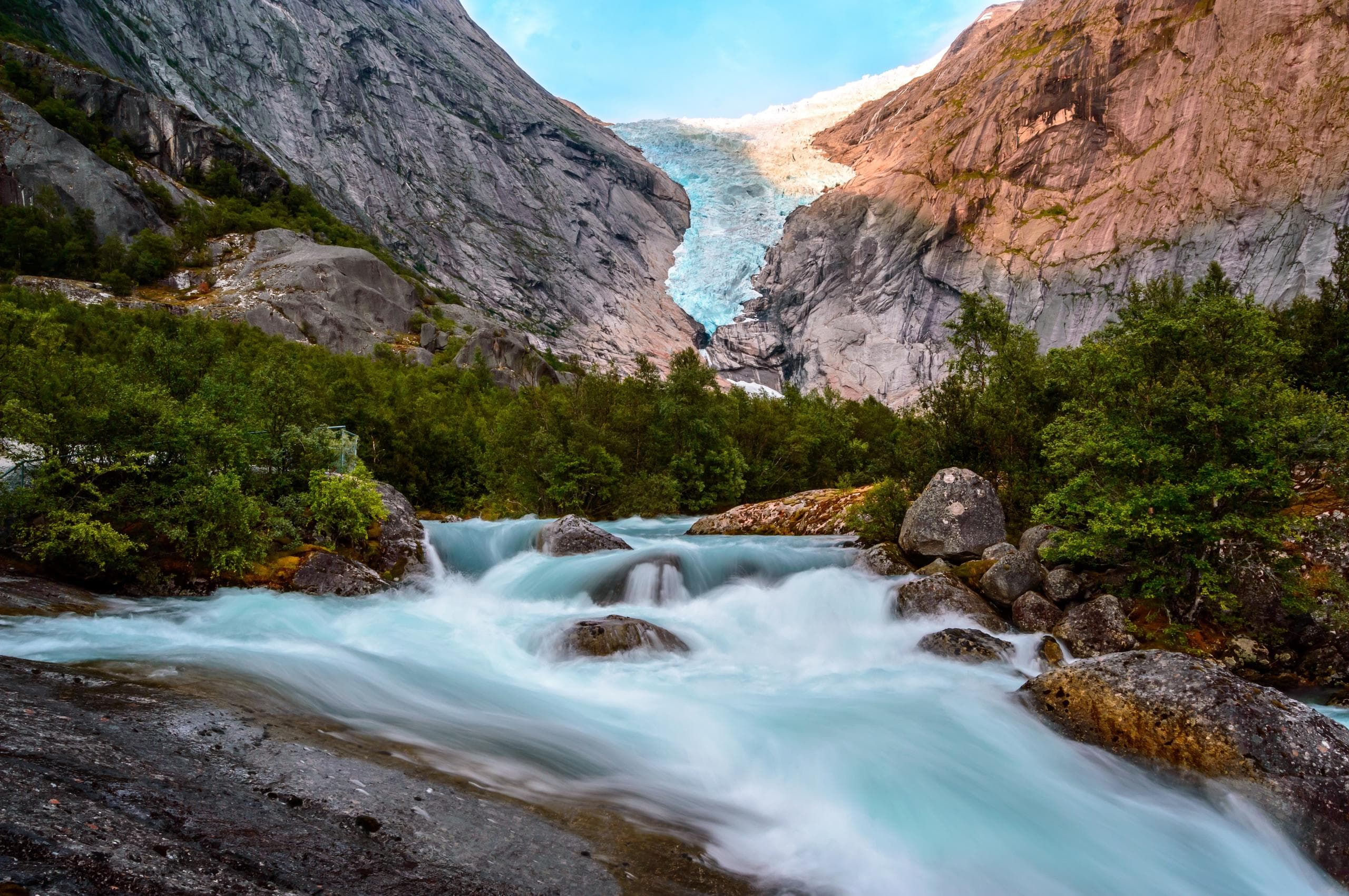 River flowing from glacier through rocky alpine valley