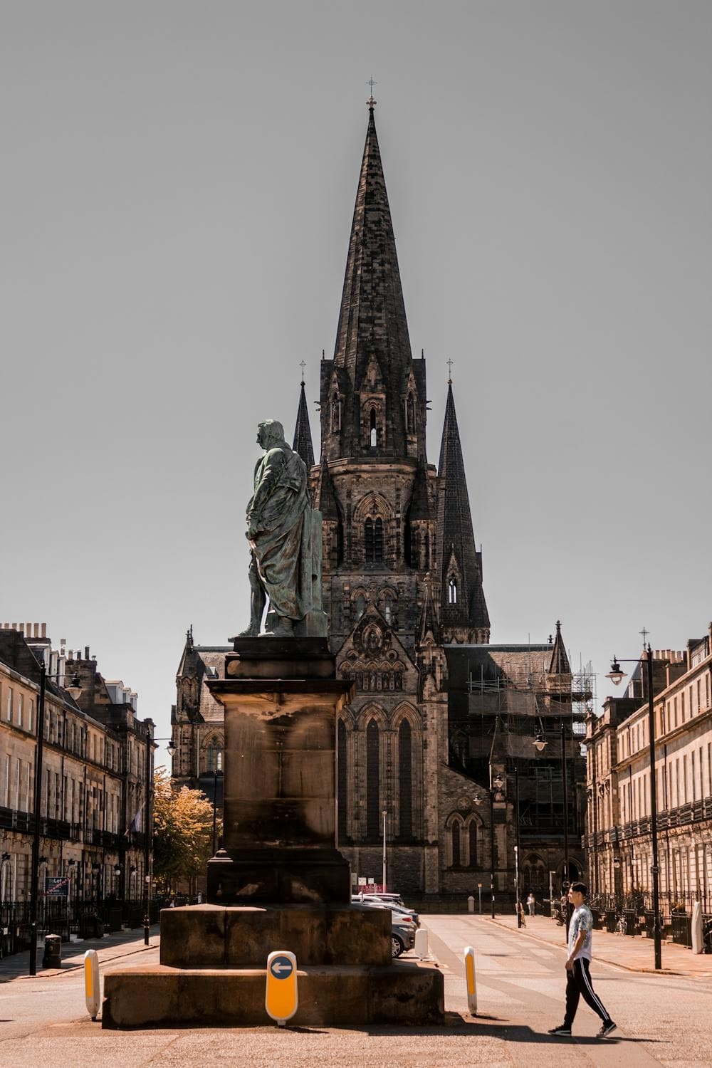 Walking past historic cathedral and statue in city square