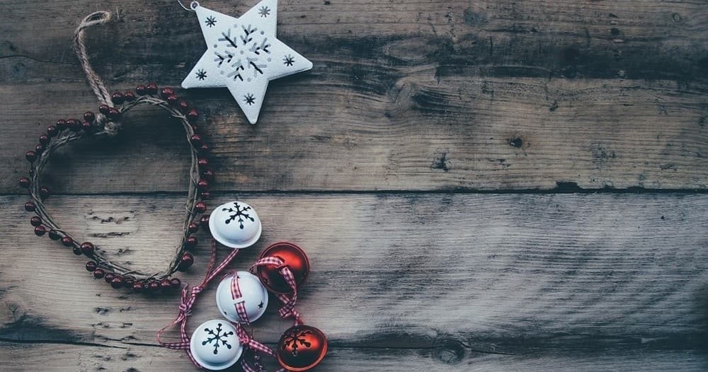 Rustic holiday ornaments on wooden plank table, festive still-life