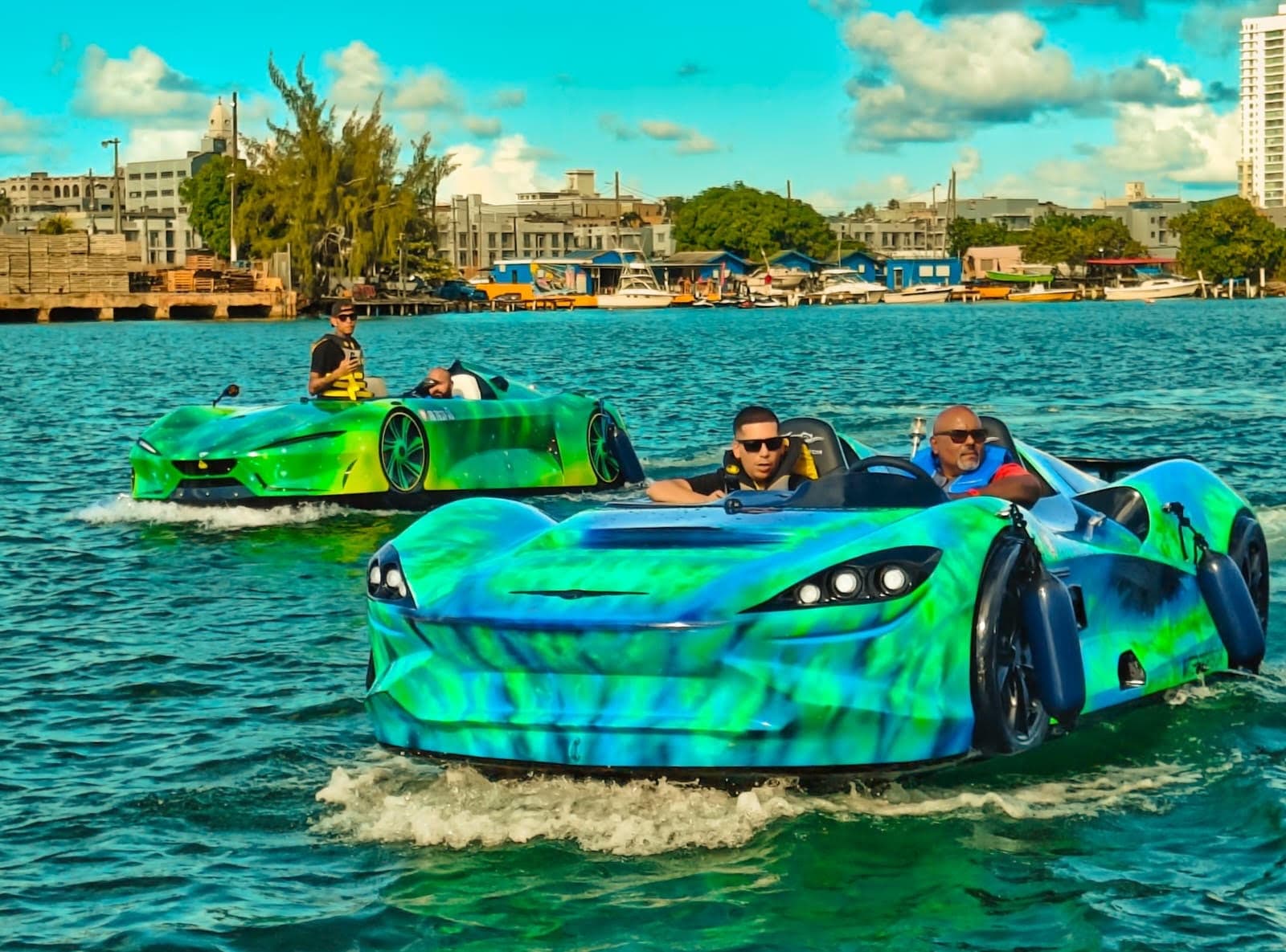 Amphibious sports cars cruising coastal city waters
