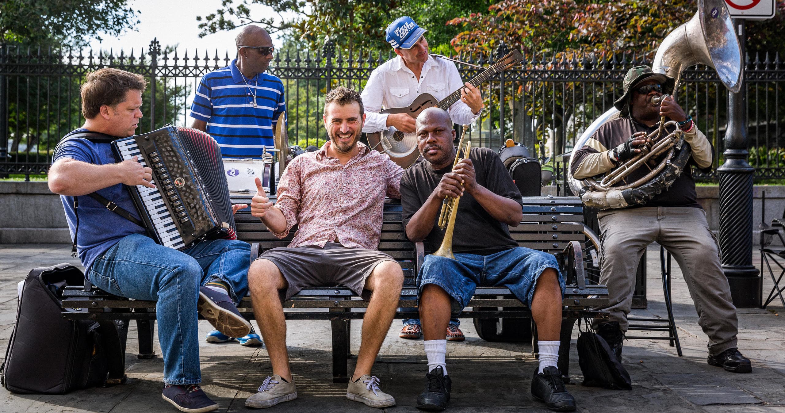 Street musicians playing jazz on bench in New Orleans park