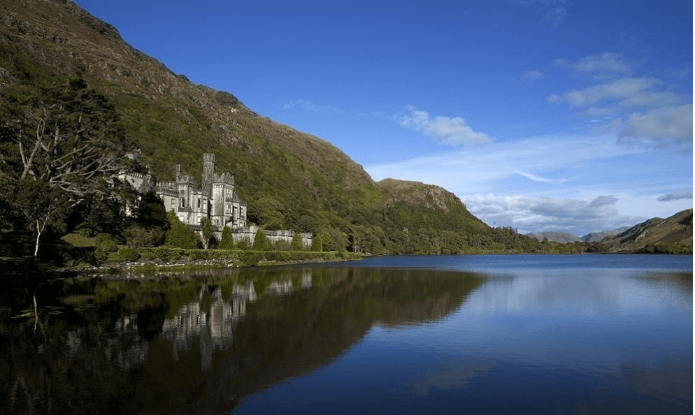 Serene lake with castle reflection in Galway region, peaceful sightseeing