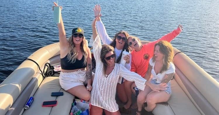 Friends celebrating on pontoon boat cruising coastal North Myrtle Beach waters