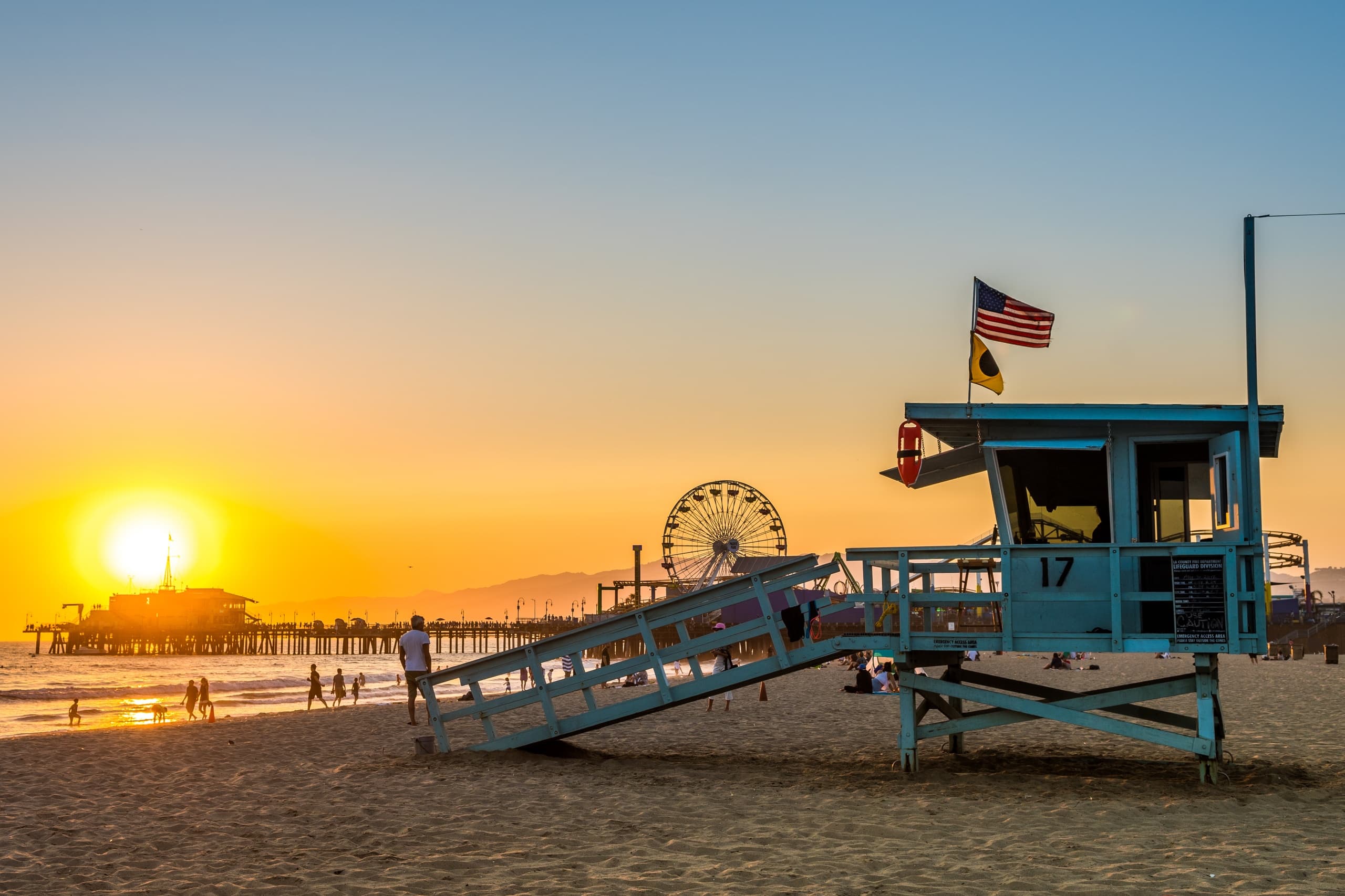Sunset beach with lifeguard tower and pier, ideal for coastal beach biking