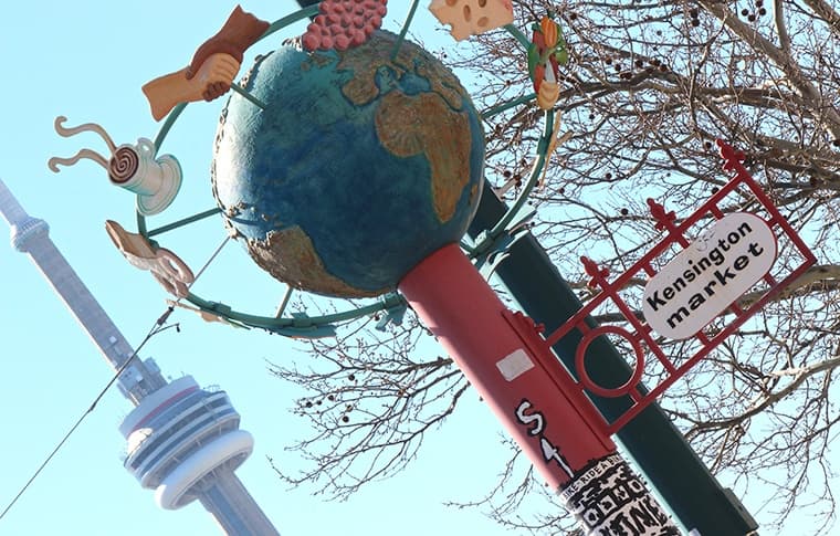 Globe sculpture with CN Tower backdrop at Toronto landmark plaza