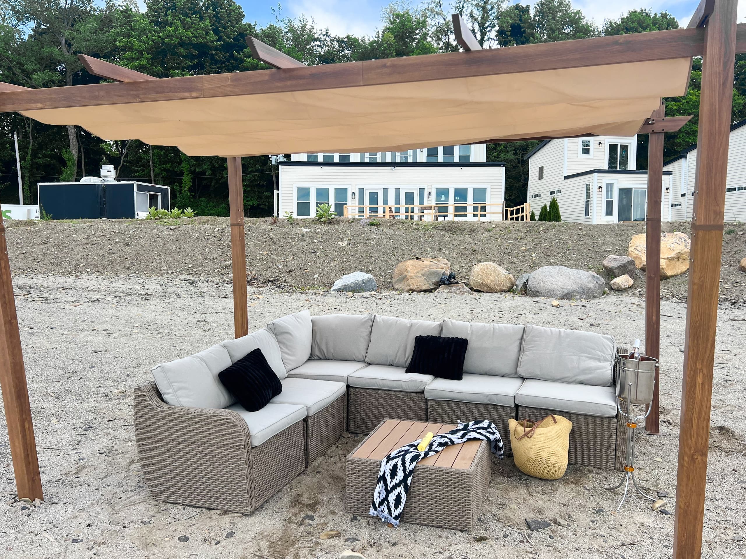 Shaded outdoor wicker lounge set on a resort sandy beach