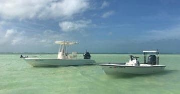 Two flats fishing boats on shallow turquoise waters in Florida Keys