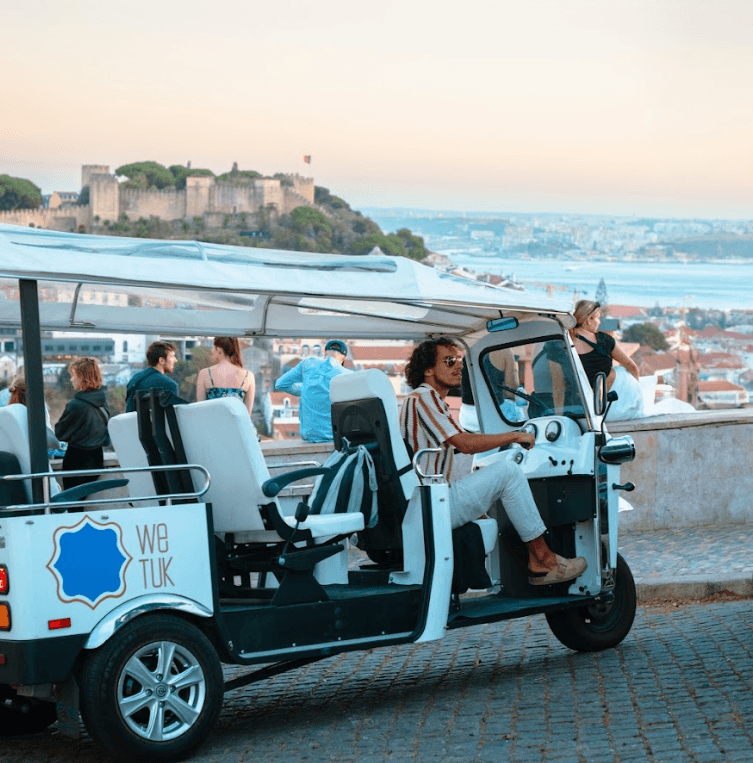 Open-air tuk-tuk sightseeing along coastal city viewpoint