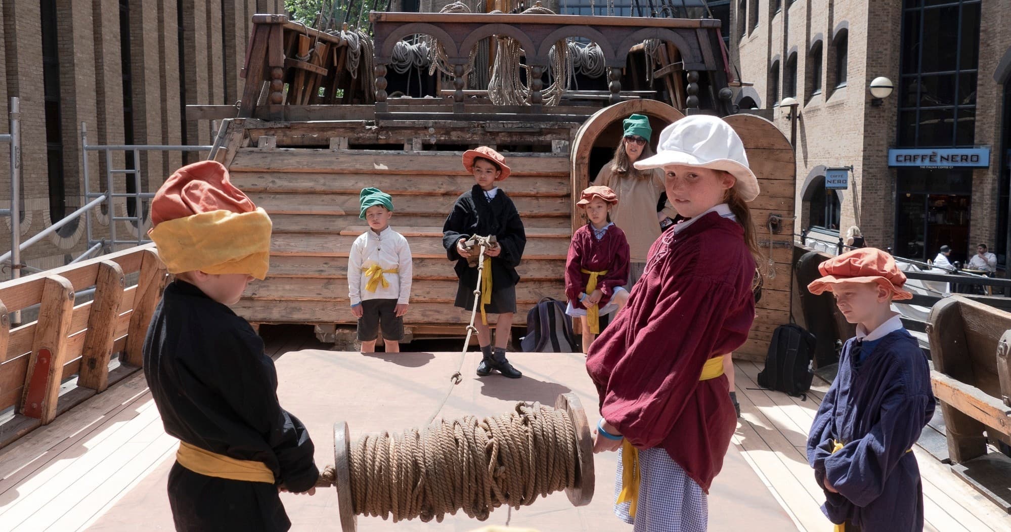 Children learning on ship deck during outdoor educational tour