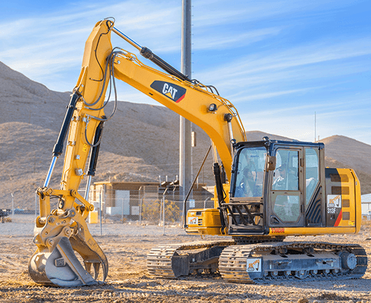 Excavator digging in desert construction pit at DigThis Vegas