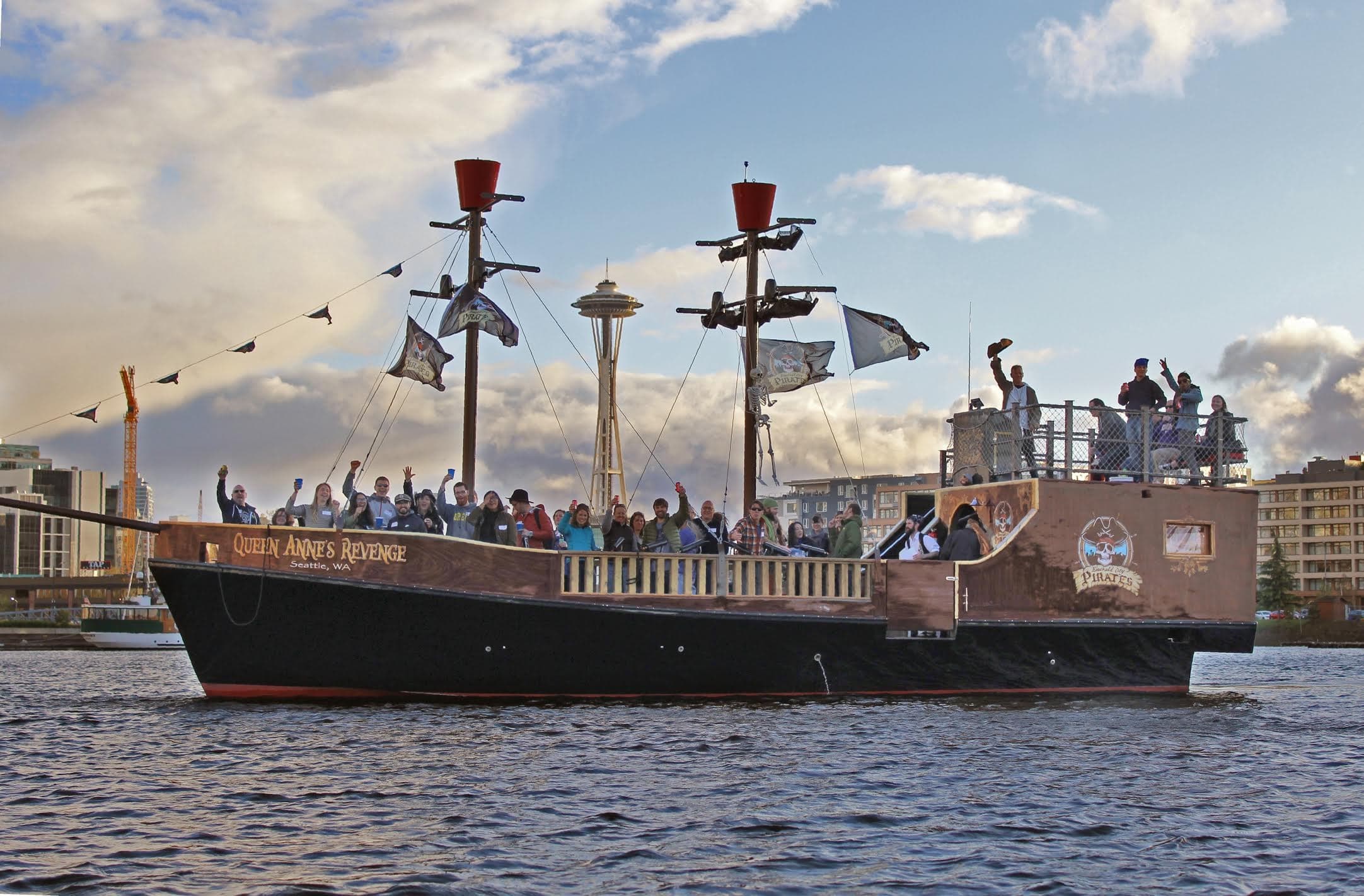 Pirate ship cruise sailing past Seattle waterfront at sunset