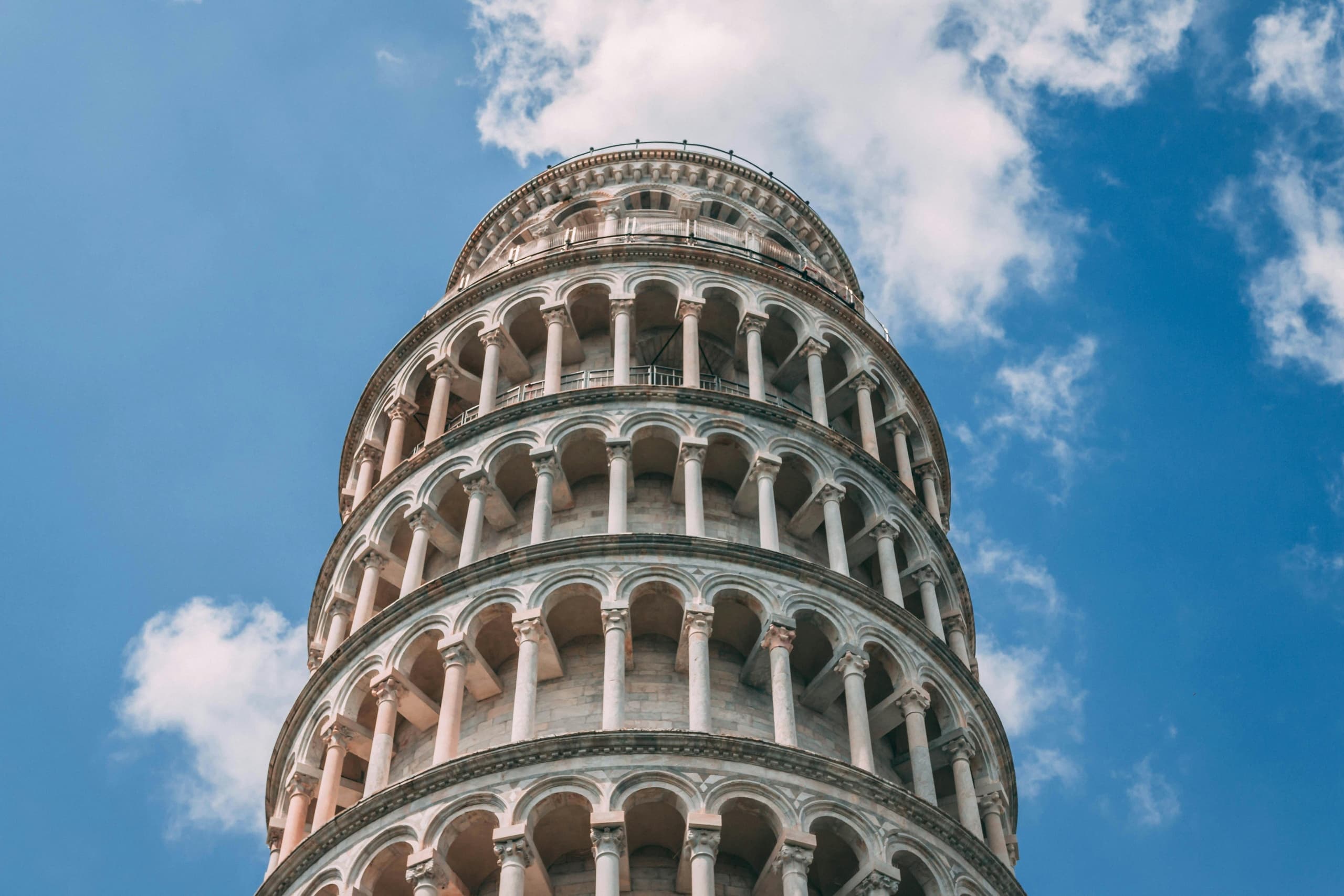 Leaning Tower of Pisa against blue sky, outdoor landmark