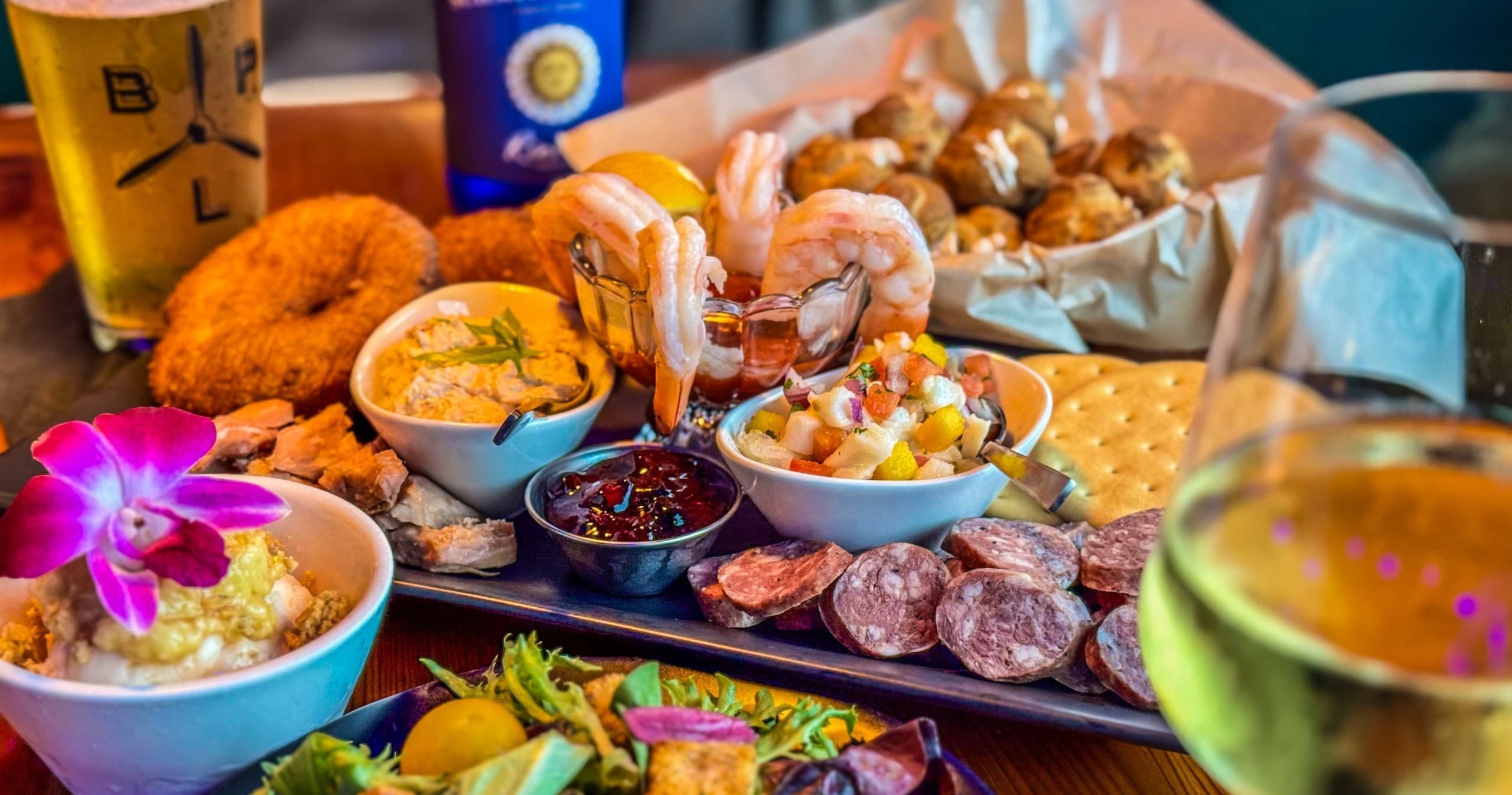 Seafood and charcuterie platter at restaurant bar with drinks