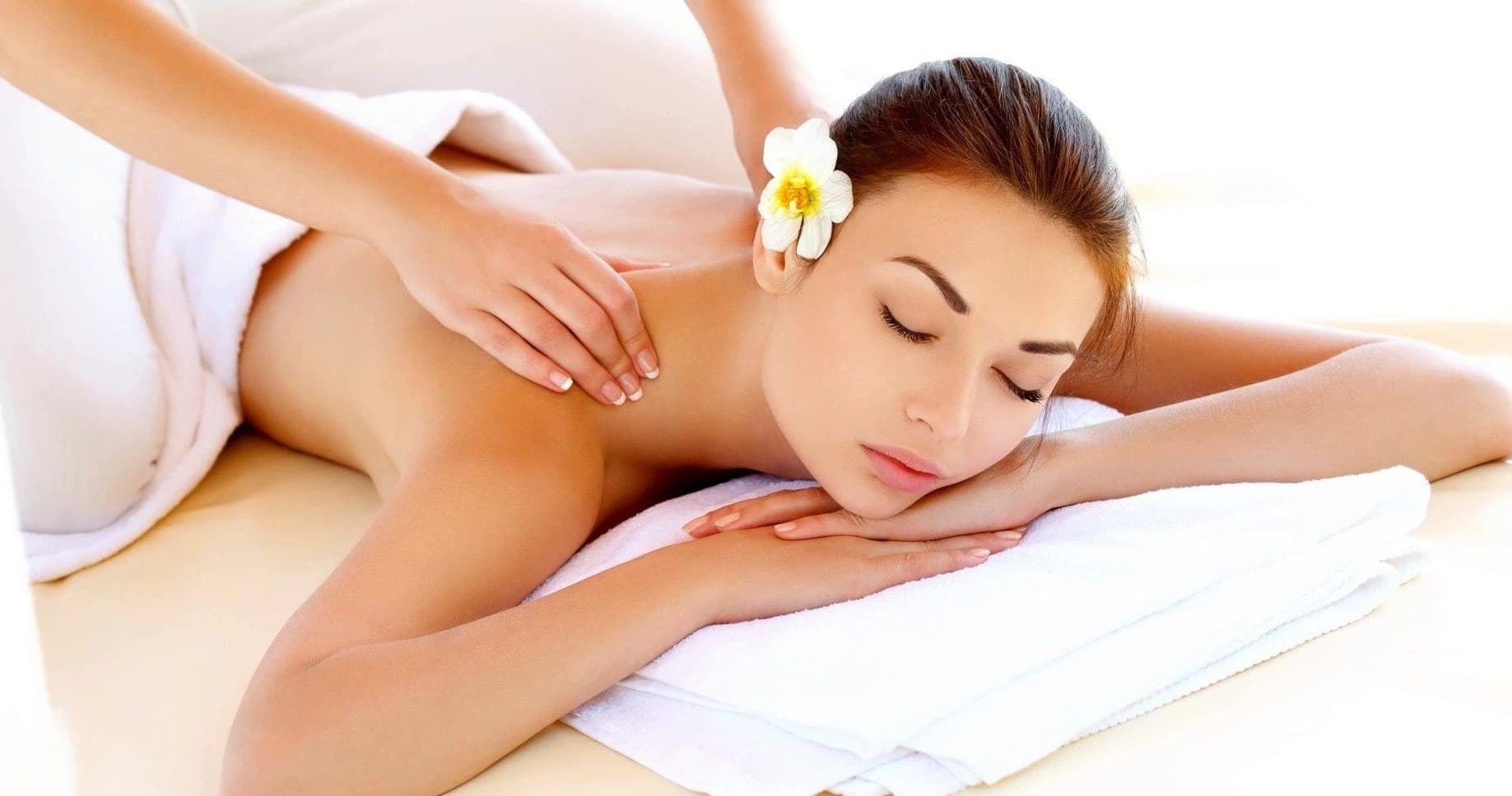 Relaxing woman receiving back massage in spa setting