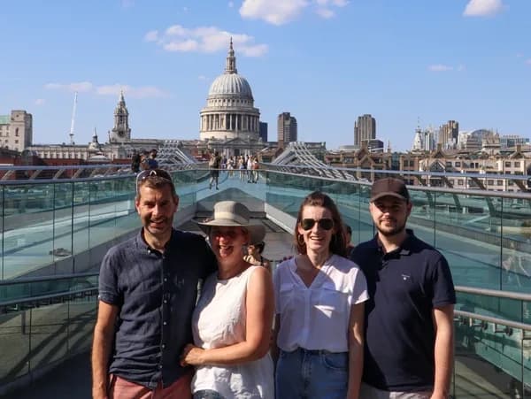 Group on Millennium Bridge with St Paul's skyline backdrop
