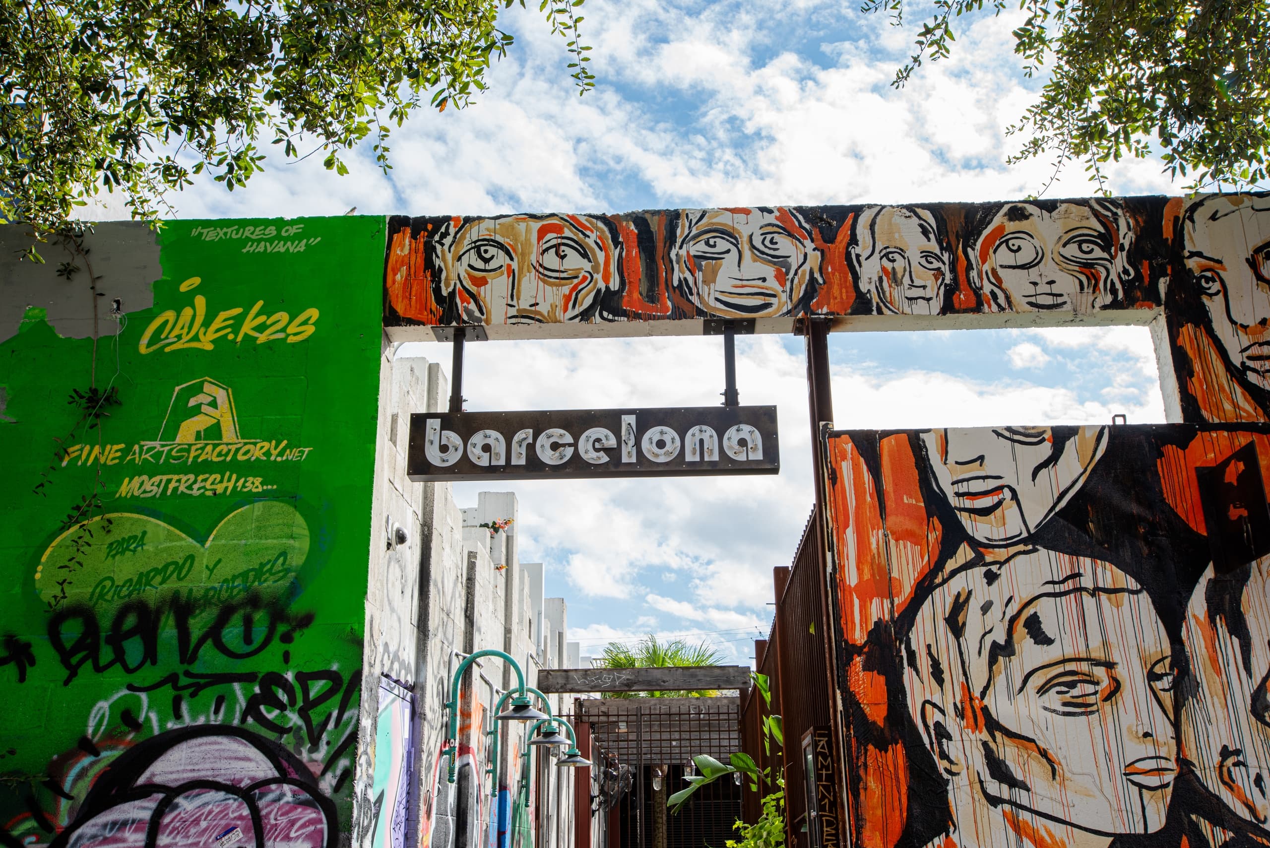 Street art murals at Barcelona alley entrance, urban exploration