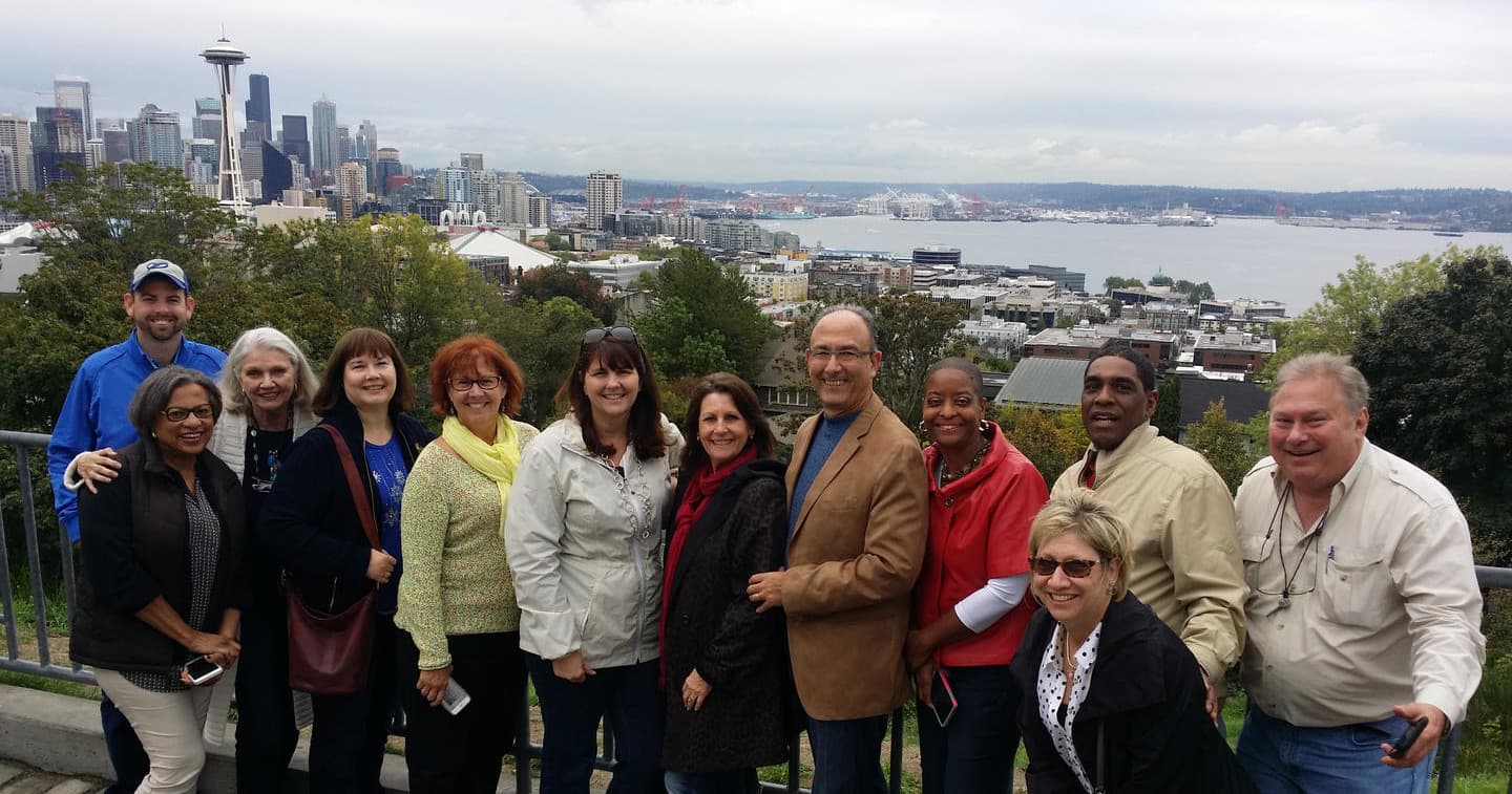 Guided walking tour group overlooking Seattle skyline and Elliott Bay