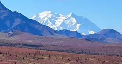 Snow-capped mountain panorama with tundra foreground hike view