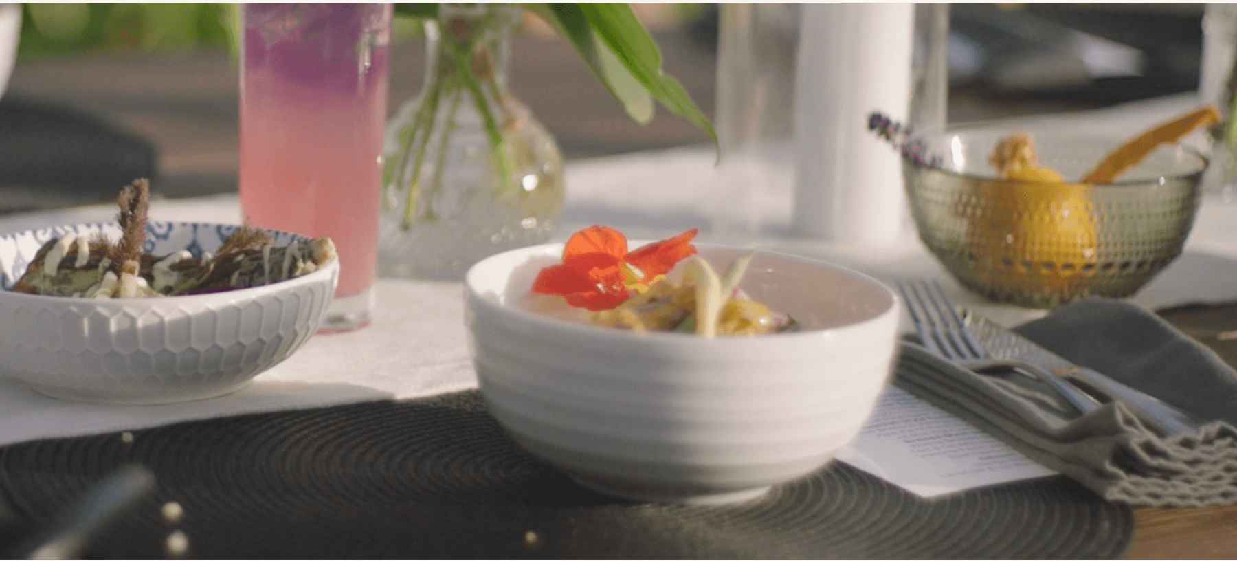 Close up bowls and desserts on styled outdoor dining table