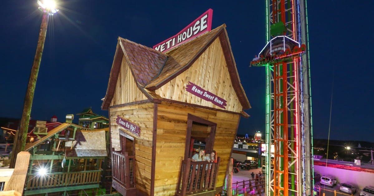 Themed drop tower attraction lit at night at Branson amusement park
