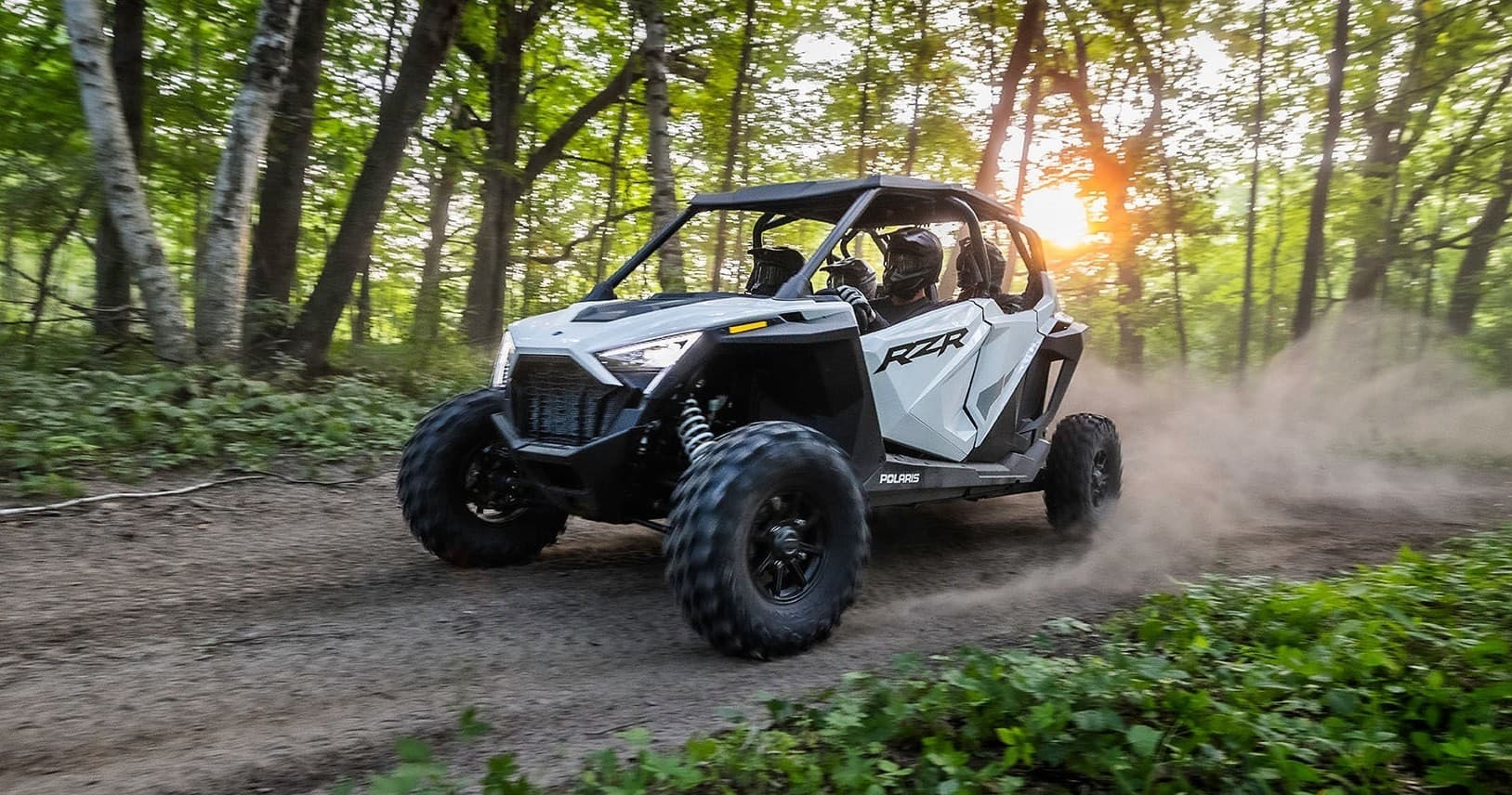 UTV rental off-road driving on wooded trail at sunset in Utah