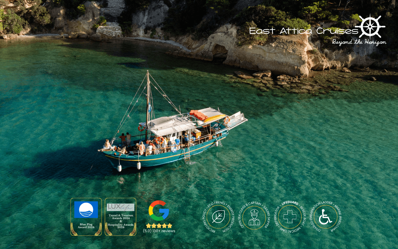Traditional day cruise boat anchored in shallow turquoise cove