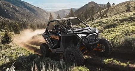 Side-by-side UTV navigating rugged hillside trails