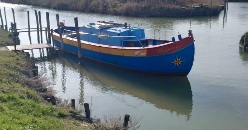 Colorful Venetian-style boat moored on a calm lagoon dock