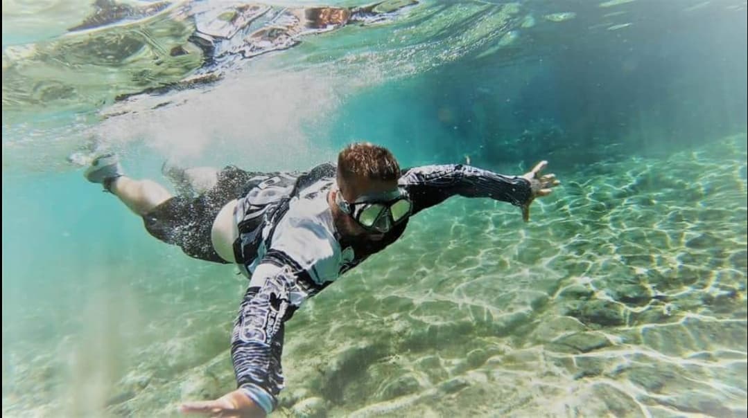 Snorkeler exploring clear shallow spring waters underwater